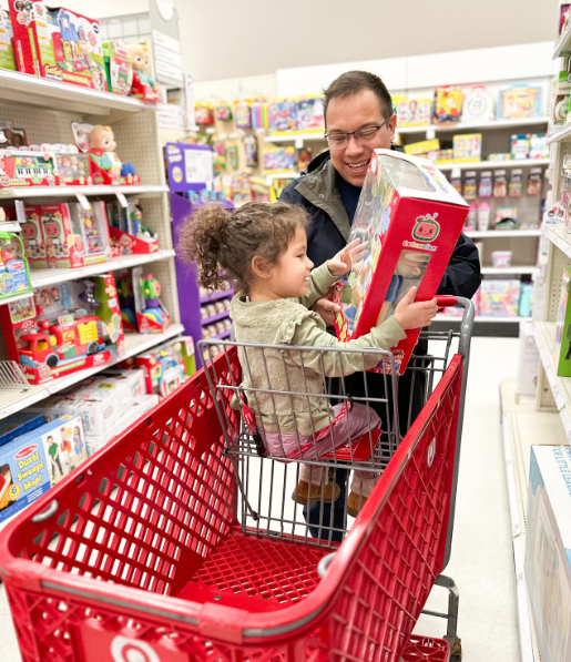 Dad and daughter shopping at Target seeking out toys influencers recommend.